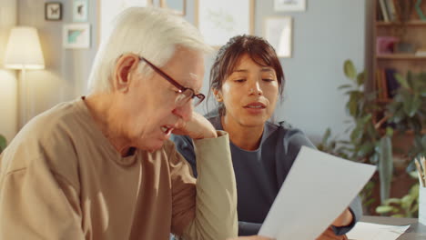 senior man and young woman co-working