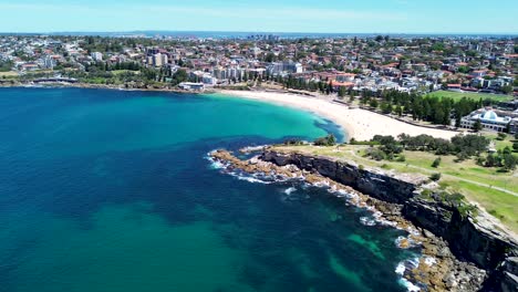 drone aerial shot of coogee bay beach beachside headland coastline cliff housing infrastructure randwick bondi maroubra eastern suburbs travel tourism sydney nsw australia 4k