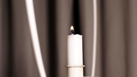 Evocative-shot-of-hand-lighting-candle.-Close-up