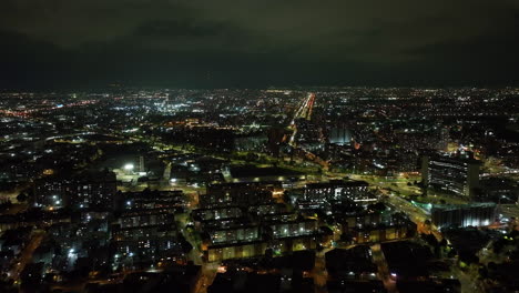 Vista-Aérea-Hacia-Edificios-De-Departamentos-Iluminados,-Noche-En-Bogotá,-Colombia.