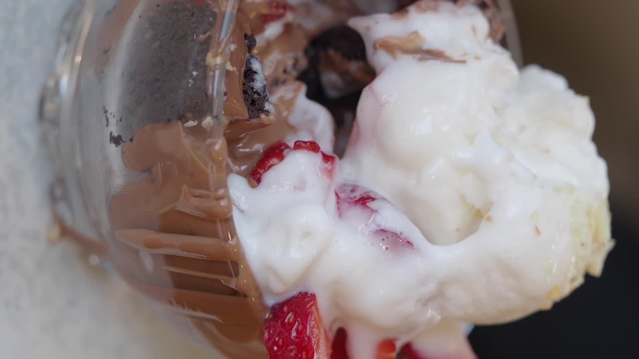 Delicious dessert with ice cream, chocolate, and strawberries