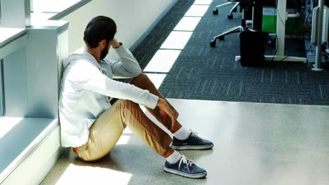 depressed male executive sitting on the floor