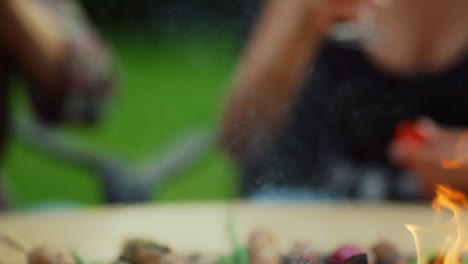 unknown girl drinking red wine outside. woman eating cherry tomato on party