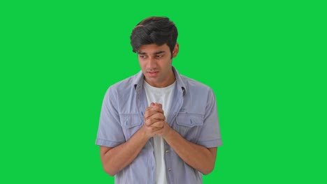 scared indian boy praying to god green screen