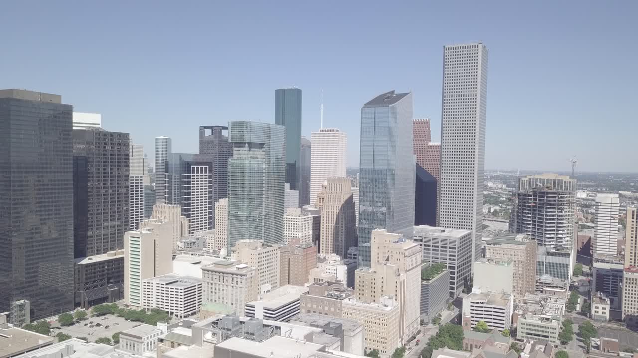 Aerial Ending Shot of Downtown Houston on a Sunny Day. Ending Drone shoot of City of Houston Texas. Texas Industrial Symbol City of Houston. Houston City Skyline with blue clear sky.