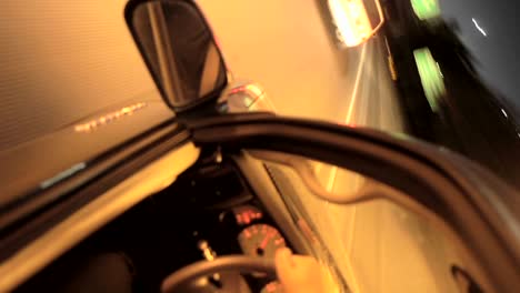 a tilted pov shot of driving through a city at night in time lapse