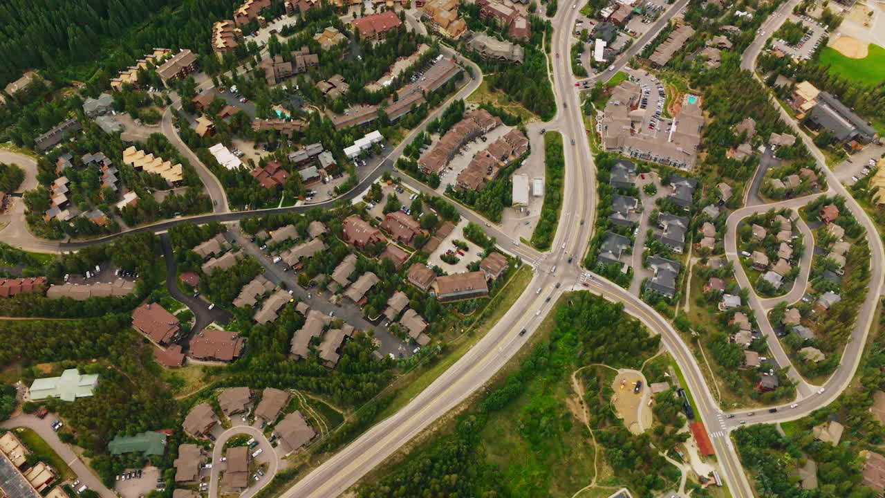 Numerous roofs of cottages in resort city of Aspen, Colorado. Beautiful houses among the pine trees in the mountains.