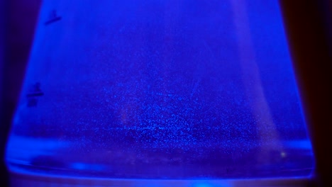 blue color backlight in the electric kettle. bubbles move in water