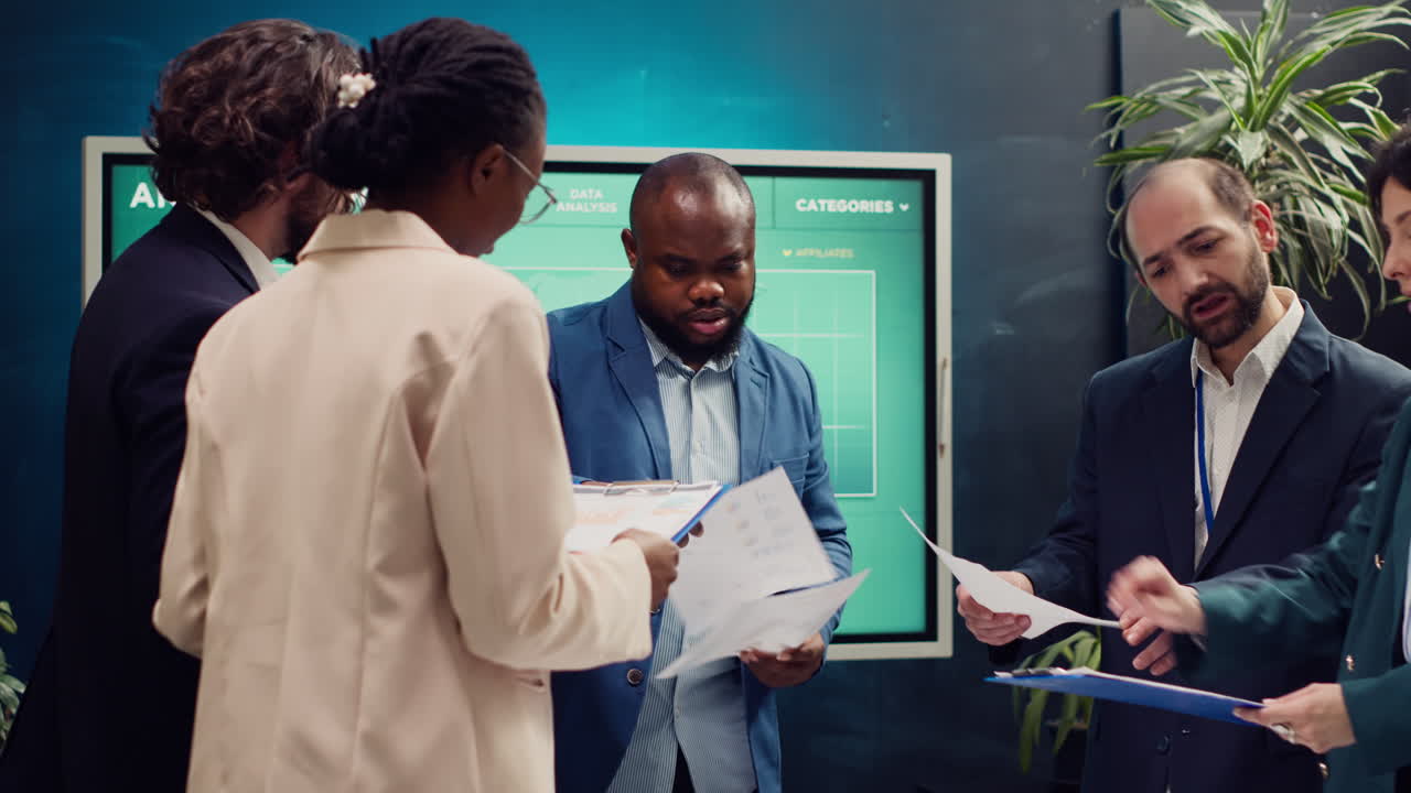 Diverse business affiliates studying market trends by reviewing finances