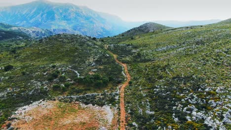 aerial view of grassland and off-road track in the middle at crete