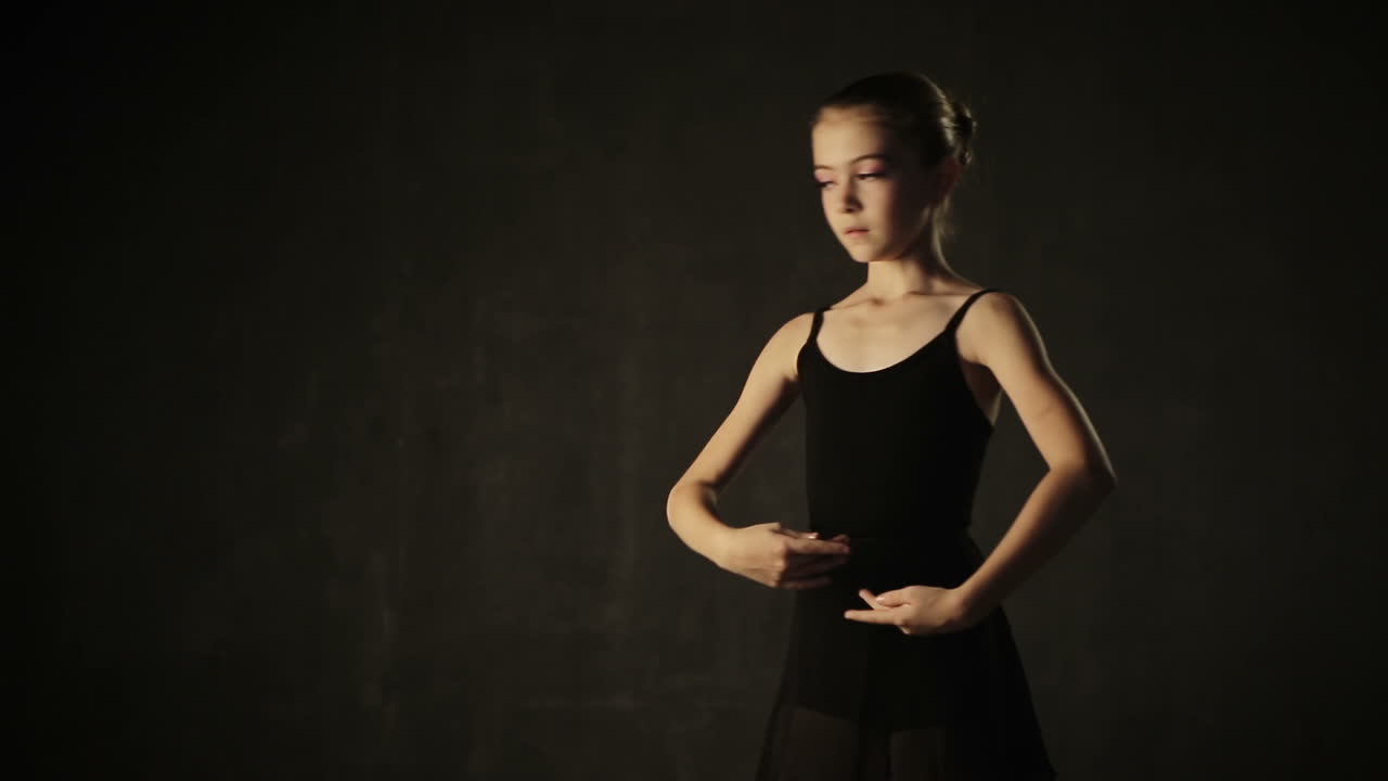 Beautiful little girl ballerina dancing in ballet studio