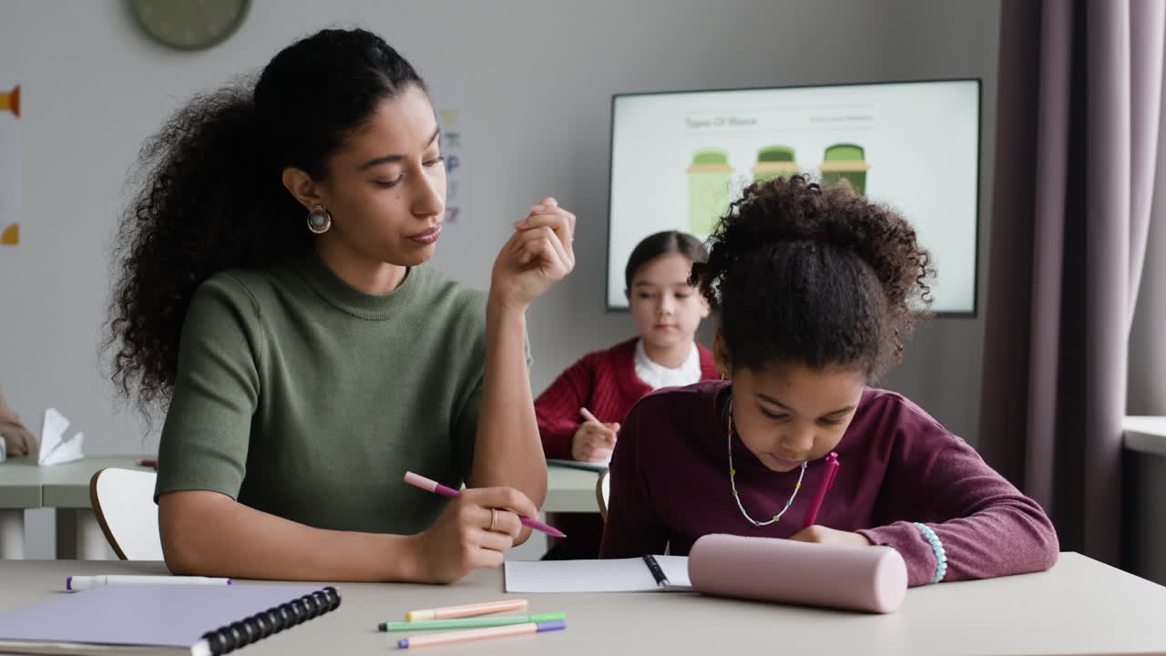 Teacher assisting a student in classroom