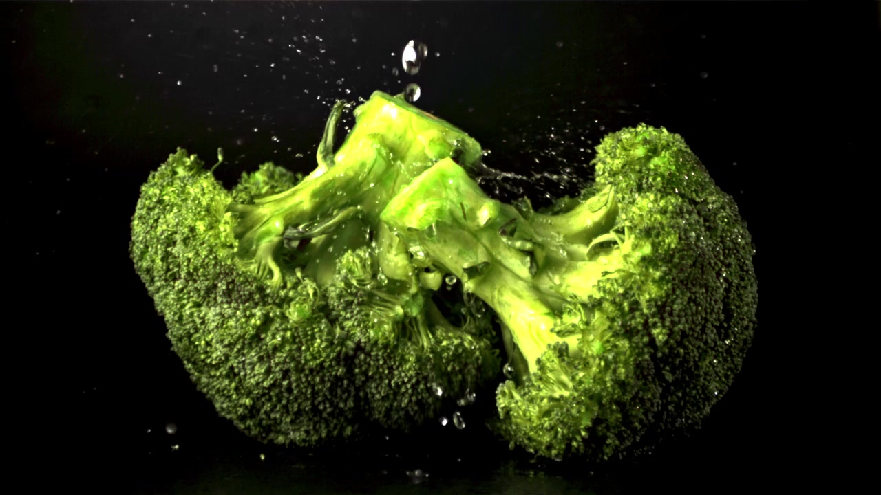 Water Splashing on Fresh Green Broccoli in Slow Motion