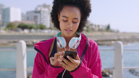 african woman, texting and phone at beach