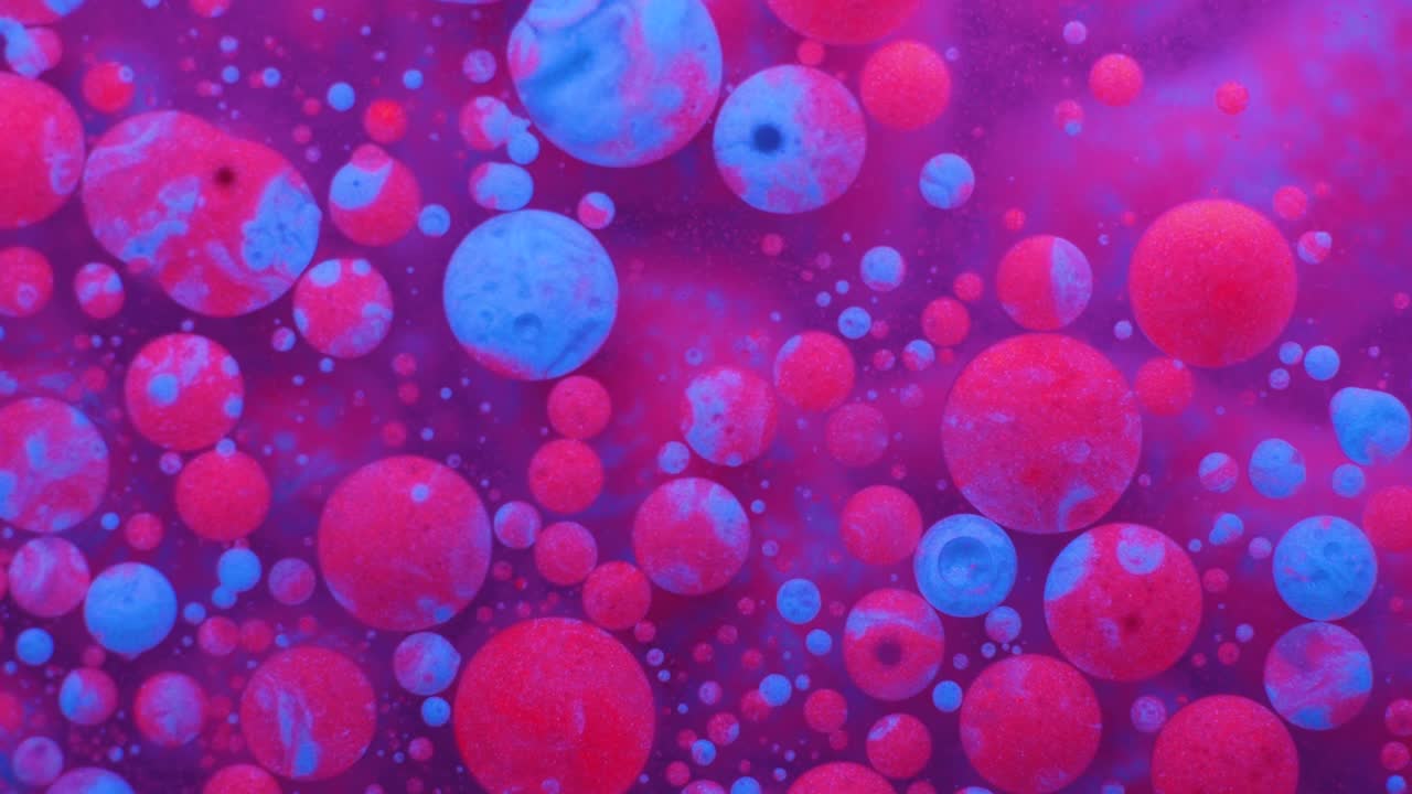 Slow Motion Bright Neon Color Bubbles Oil Beautiful Fluorescent Paint Sparkling Color Moving Multicolor Close up. Acrylic Neon Paint. Fantastic Surface. Abstract Colorful Transformation Gravitation.