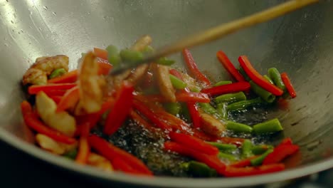 cook prepares fresh vegetables in a frying pan in boiling oil 3