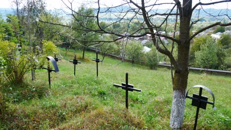 pedestal up shot of an old cemetery in front of a mountain village