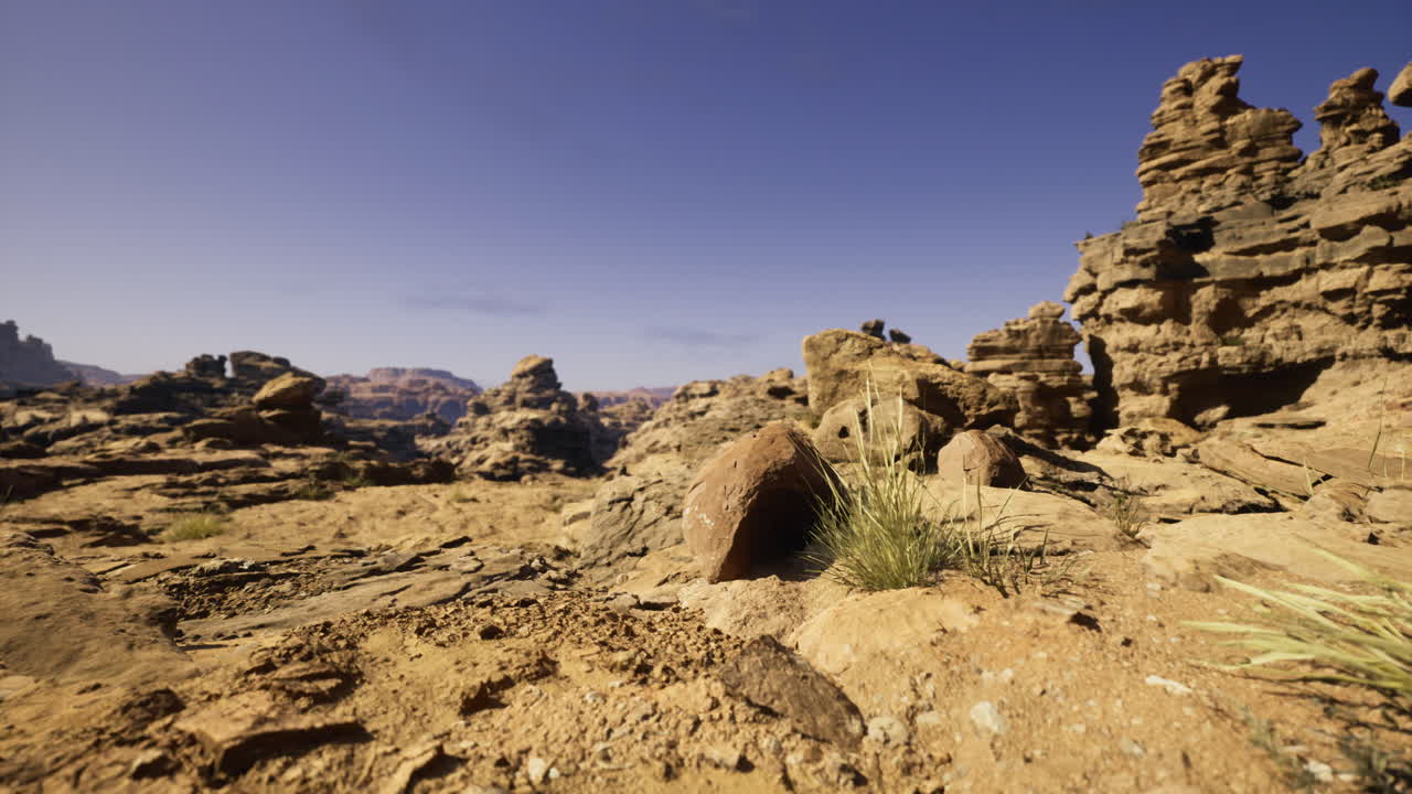 Unique rock formations in a desert landscape under clear blue sky