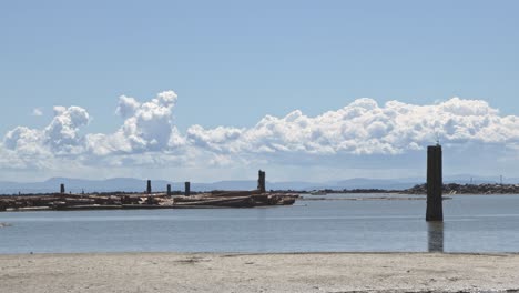 wreck beach, clouds  and logs