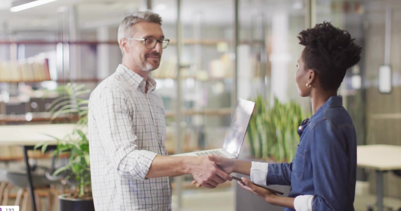 Man pointing tablet and activating floating search, user icons while mentoring analytics colleague