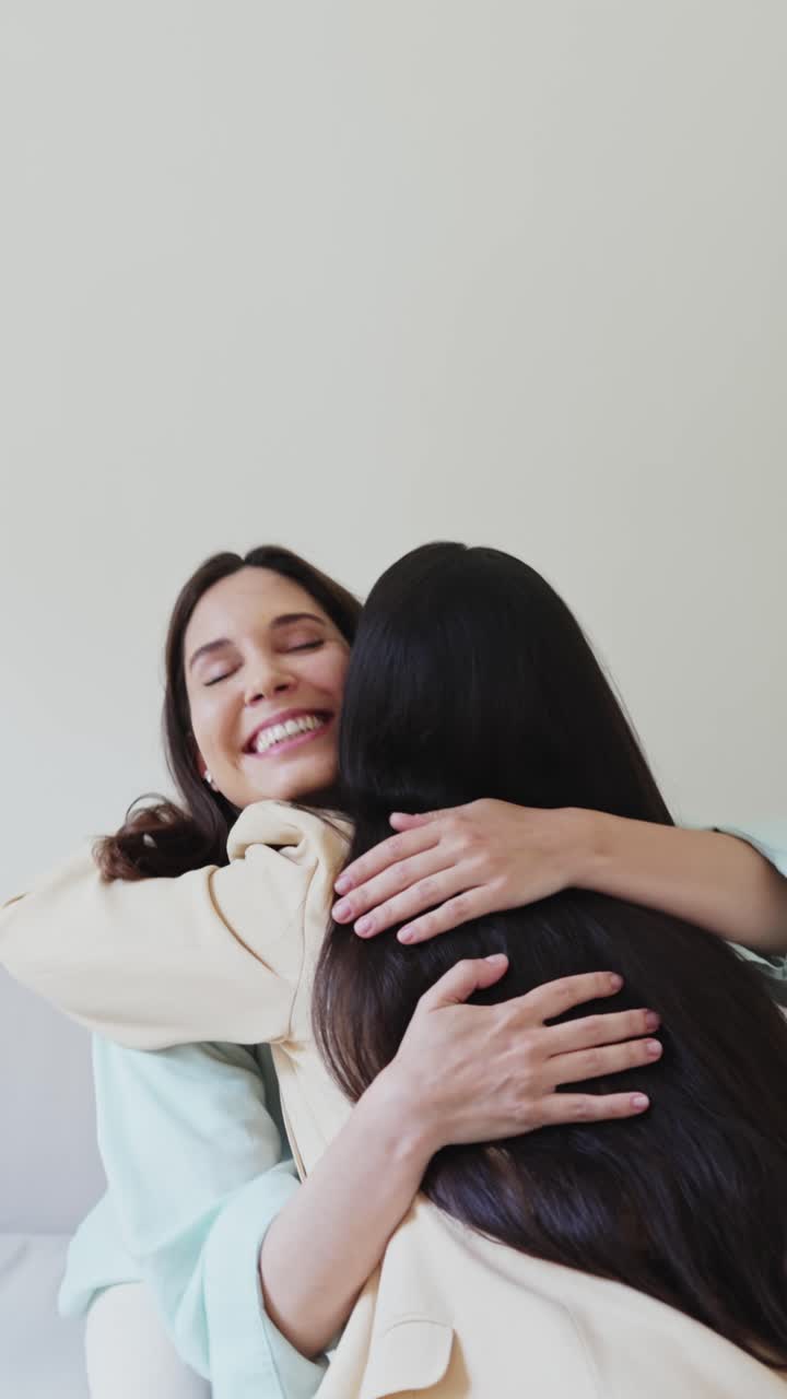 Due donne felici che si abbracciano e sorridono con affetto