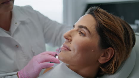 beautician injecting woman face in cosmetology clinic for lifting close up.