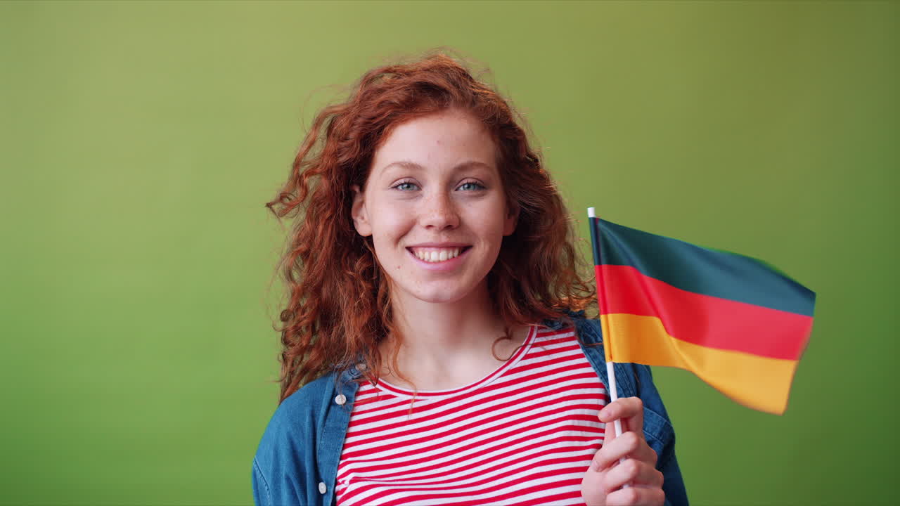 Young woman holding a German flag