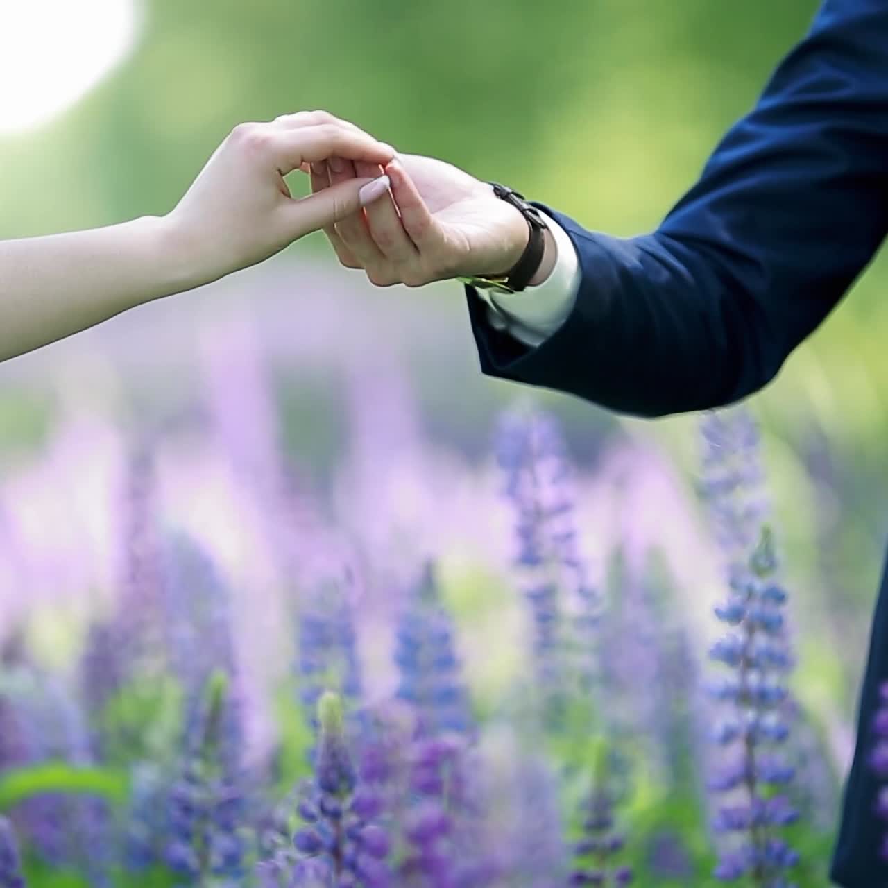 Couple Standing In A Field Of Lupine