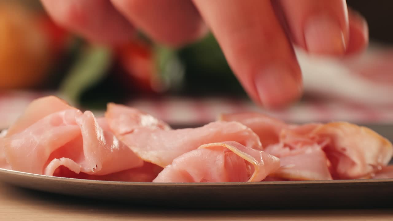 Ham italian mordatella, man Slices Of Traditional Italian antipasti mortadella sausage on a wooden cutting board, close up macro of chicken or turkey jamon, fat breakfast dish.