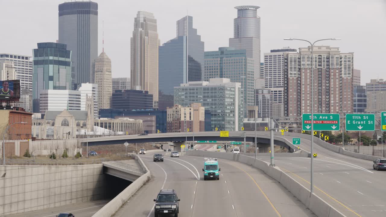 Cars Driving On Freeway With Minneapolis Skyline In Background, Minnesota, USA - Wide Shot
