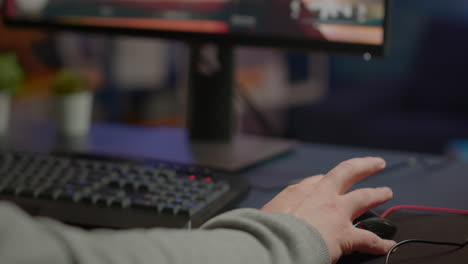 close-up of man hands gamer playing video game using rgb keyboard