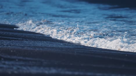 the powerful waves break around the sandy shallows on the ersfjord beach