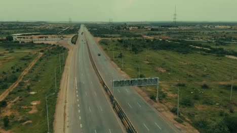 aerial flying back over karachi motorway with pylons in background