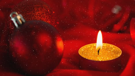 falling snow and christmas candle with bauble decorations