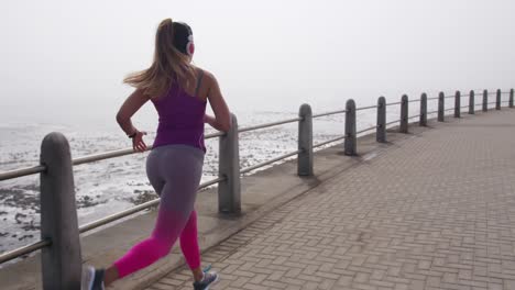 mujer caucásica corriendo en los muelles