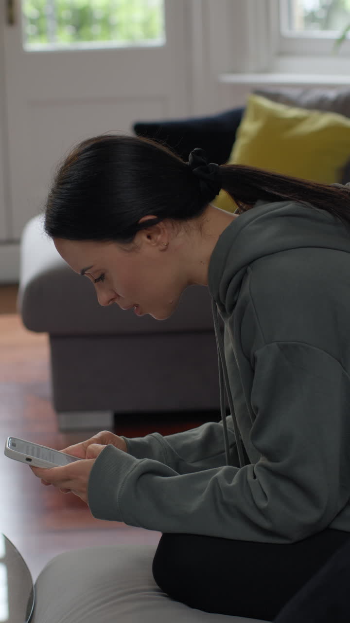 Vertical Video Of Stressed And Worried Woman With Financial Worries About Cost Of Living Crisis Debt And Paying Bills At Home Looking At Mobile Phone 1