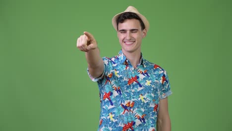 young handsome tourist man pointing finger