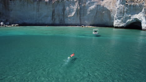 aerial view of person that swims in turquoise water