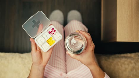 woman taking medication in pajamas