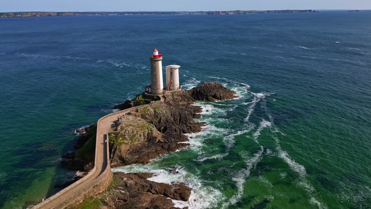 Aerial of Petit Minou lighthouse centered on rocky coast near Plouzane, Brittany, France, establishing pullback