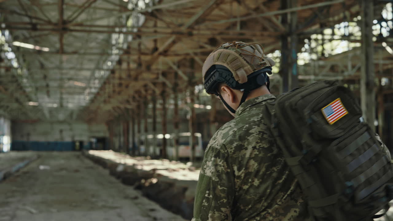 Soldier in Camouflage Uniform in an Abandoned Building
