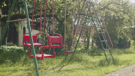 wide shot of a typical german swing set in the garden on a sunny spring day