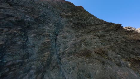 FPV-drone-flying-uphill-to-the-top-of-one-of-the-mountain-ridges-along-the-Grossglockner-Alpine-road-in-Austria