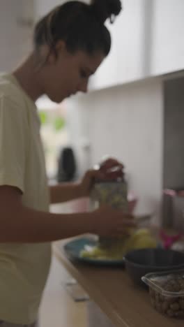 woman grating potatoes in a kitchen