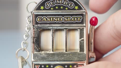 pull the lever, toy slot machine, watch the spinning symbols, hope to win