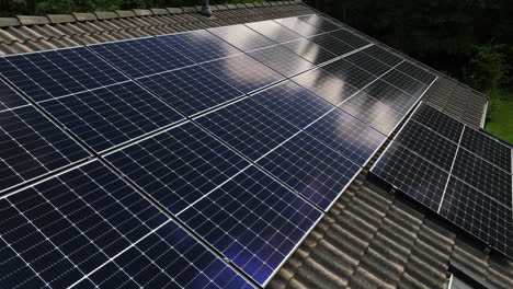 cloud reflection from a photovoltaic system n a house roof - aerial view