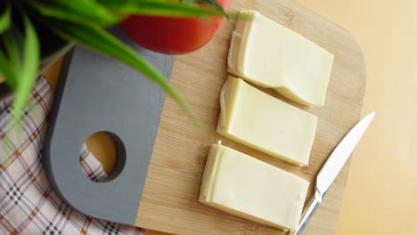 sliced cheese on a wooden cutting board