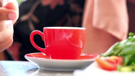 woman having turkish coffee and salad at a cafe