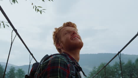 closeup joyful backpacker enjoy landscape mountains. positive man enjoy hiking.