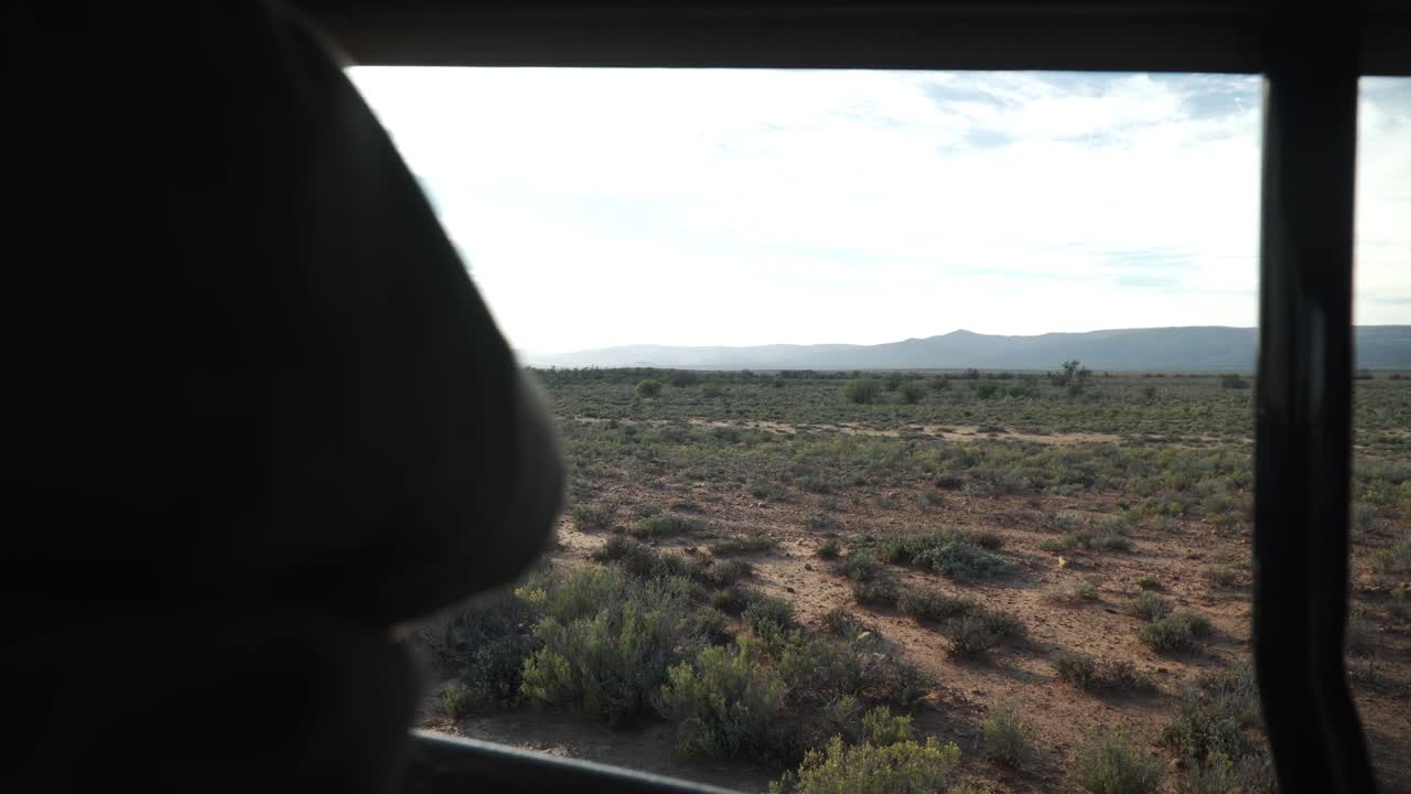Reveal A Woman Riding A Caravan On Safari